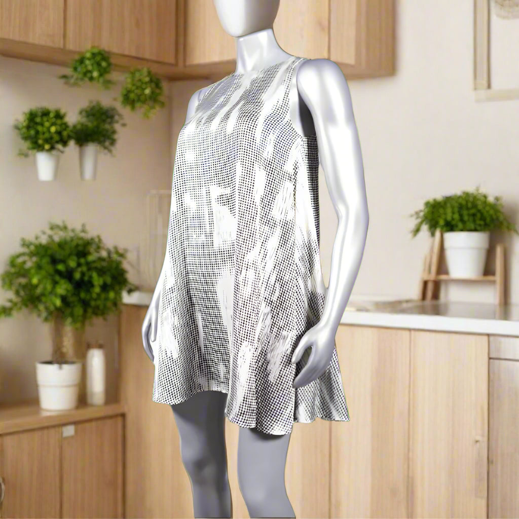 Beige silk A line round neck dress with black digital print on it.